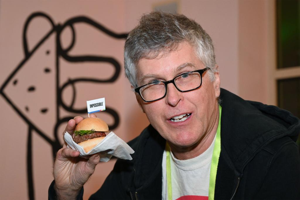 Impossible Foods CEO Pat Brown holds up an Impossible Burger 2.0.