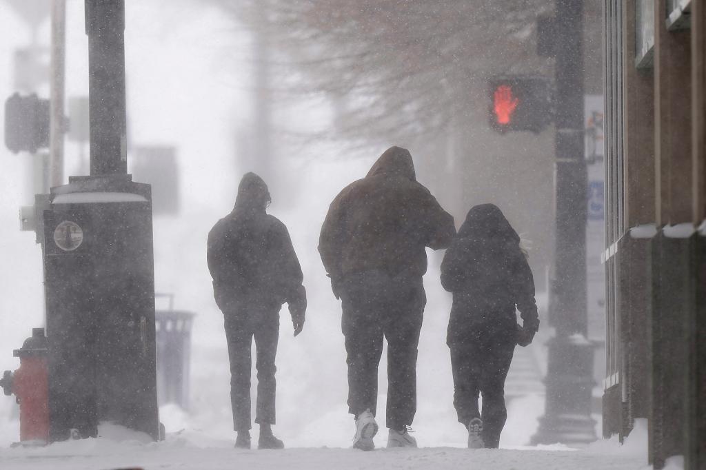 k among blowing snow in downtown Kansas City, Mo., as a winter storm passes through the region Thursday, Feb. 17, 2022.