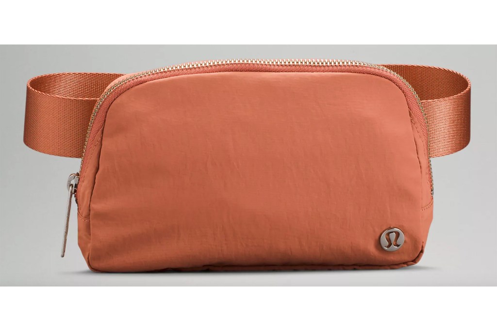 A peach colored lululemon belt bag