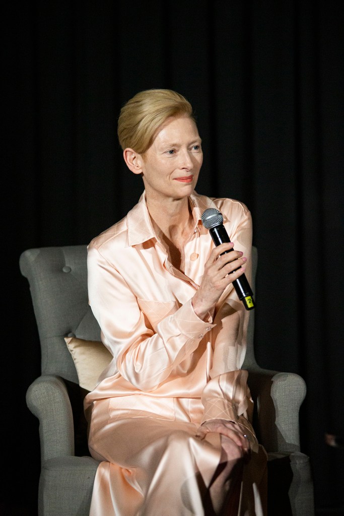 Tilda Swinton in a pink silk suit.