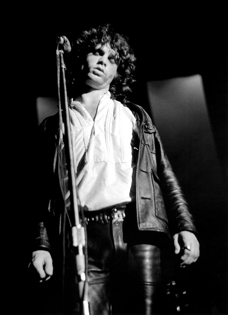 Jim Morrison onstage with his eyes closed.