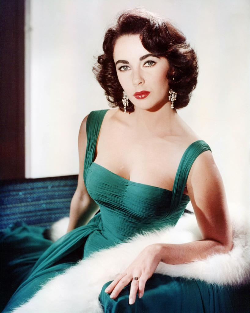 Elizabeth Taylor poses in a a green gown.