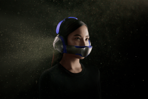 Woman wearing new Dyson air purifier and headphones