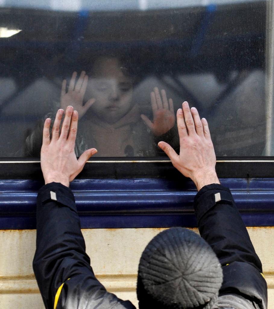 A man gestures in front of an evacuation train at Kyiv central train station.