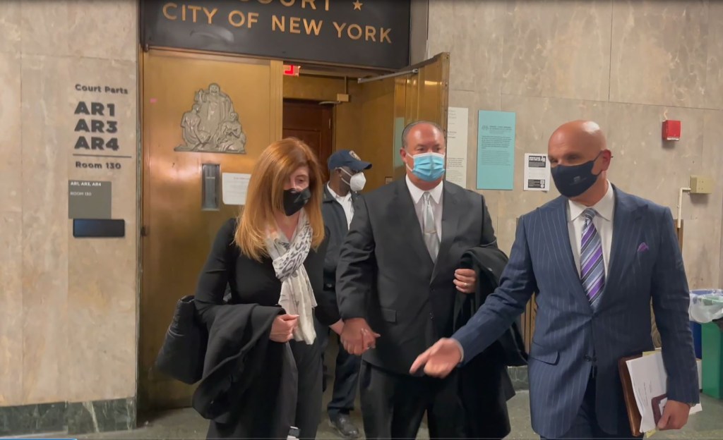 Daniel and Caroline Pazienza leave court after their daughter's arraignment.