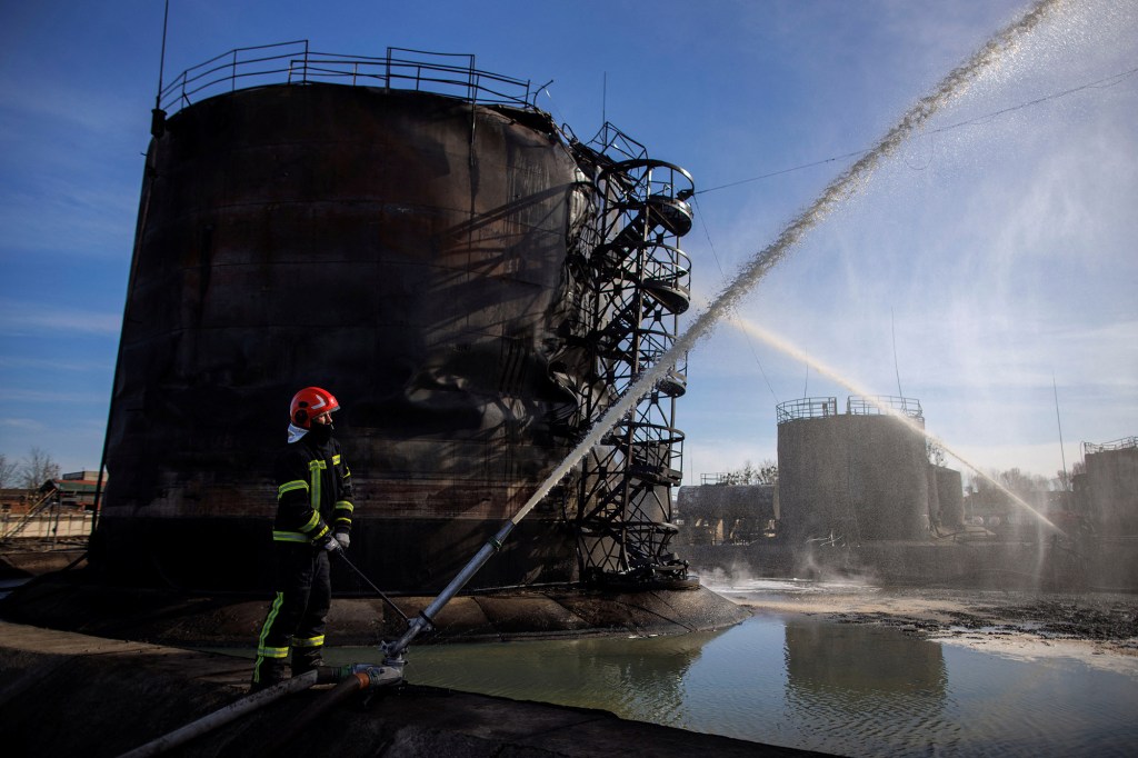 Firefighters operate at a damaged oil depot following a Russian missile attack in the city of Lviv, Ukraine on March 27, 2022.