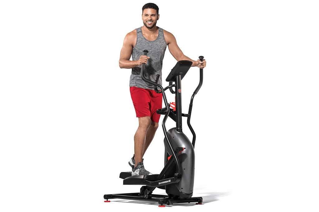 Man on a slim black elliptical 