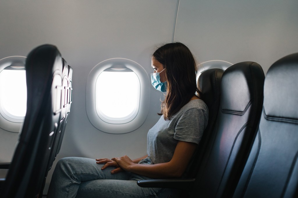 Masked woman air traveler