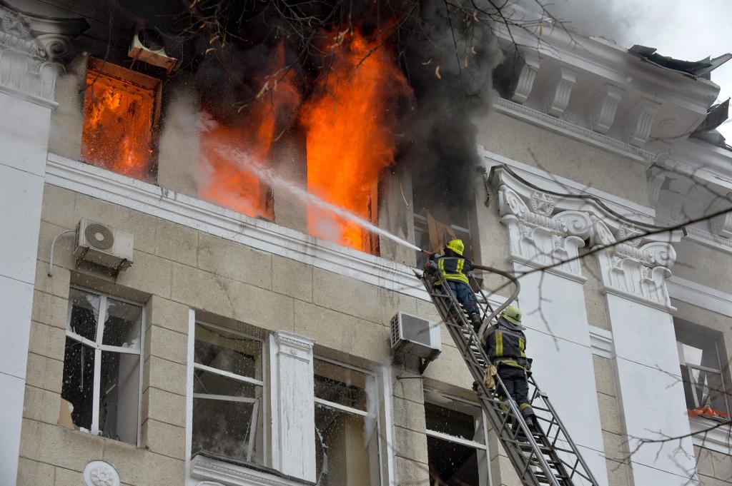 Firefighters work to contain a fire in the complex of buildings housing the Kharkiv regional SBU security service and the regional police