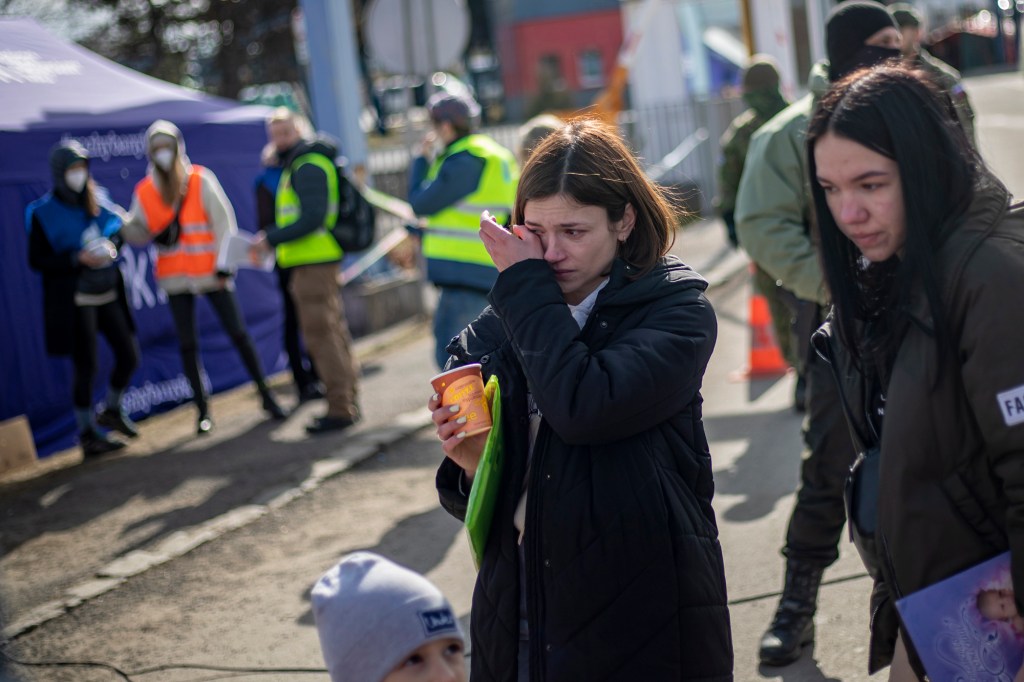 A woman reacts as as people fleeing Ukraine arrive to Slovakia through the border crossing on March 2, 2022.