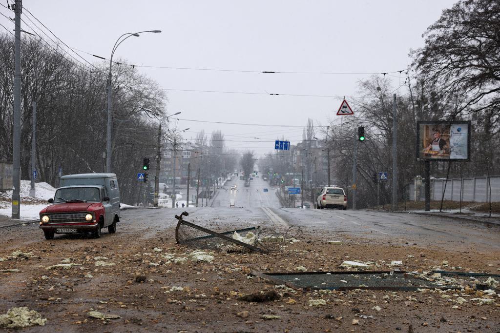 A resident drives through yesterday's blast site after an attack targeted the TV tower as Russia's invasion of Ukraine continues.