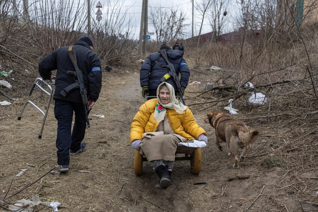 An elderly woman getting evacuated with the assistance of Ukrainian servicemen in Irpin. 