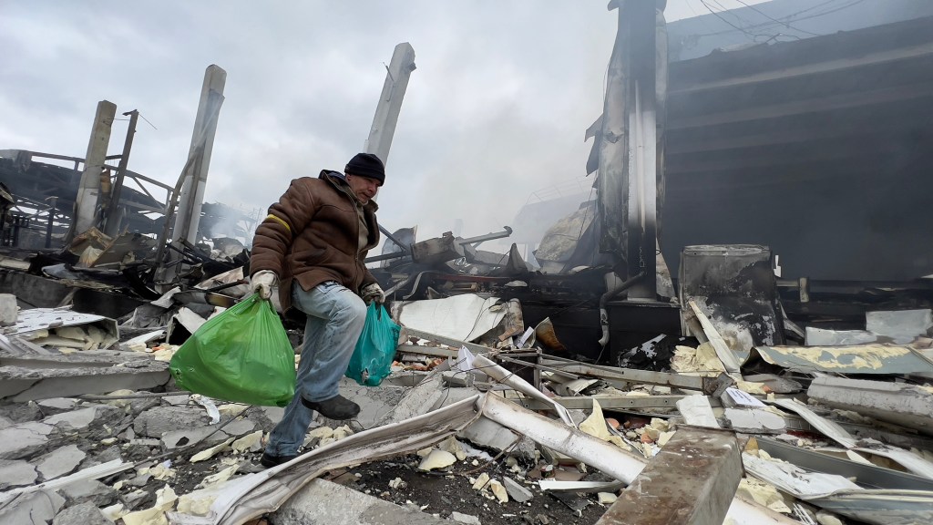 A man walking through debris in the city of Hoholiv after Russian missile shelling  on March 13, 2022.