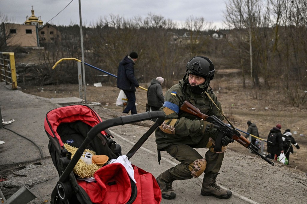 A Ukrainian soldier attempting to evacuate people from the city of Irpin on March 13, 2022.