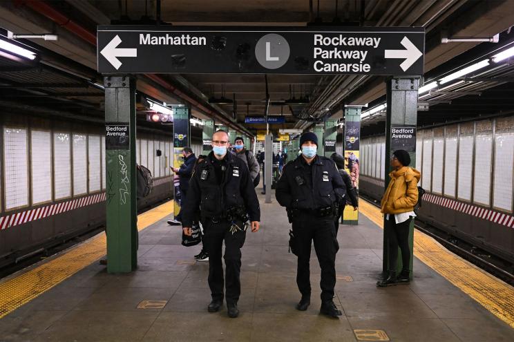 NYPD Transit District 33 officers Gautreaux (right) and Olsen (left) target subway turnstile jumpers with a $100 summonses at the Bedford avenue L subway station in Williamsburg Brooklyn.