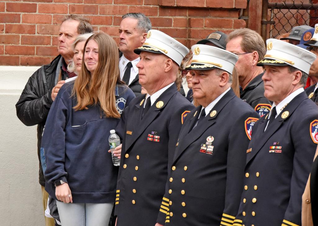 Possible family members watch the ceremony honoring the late firefighter Timothy Klein.