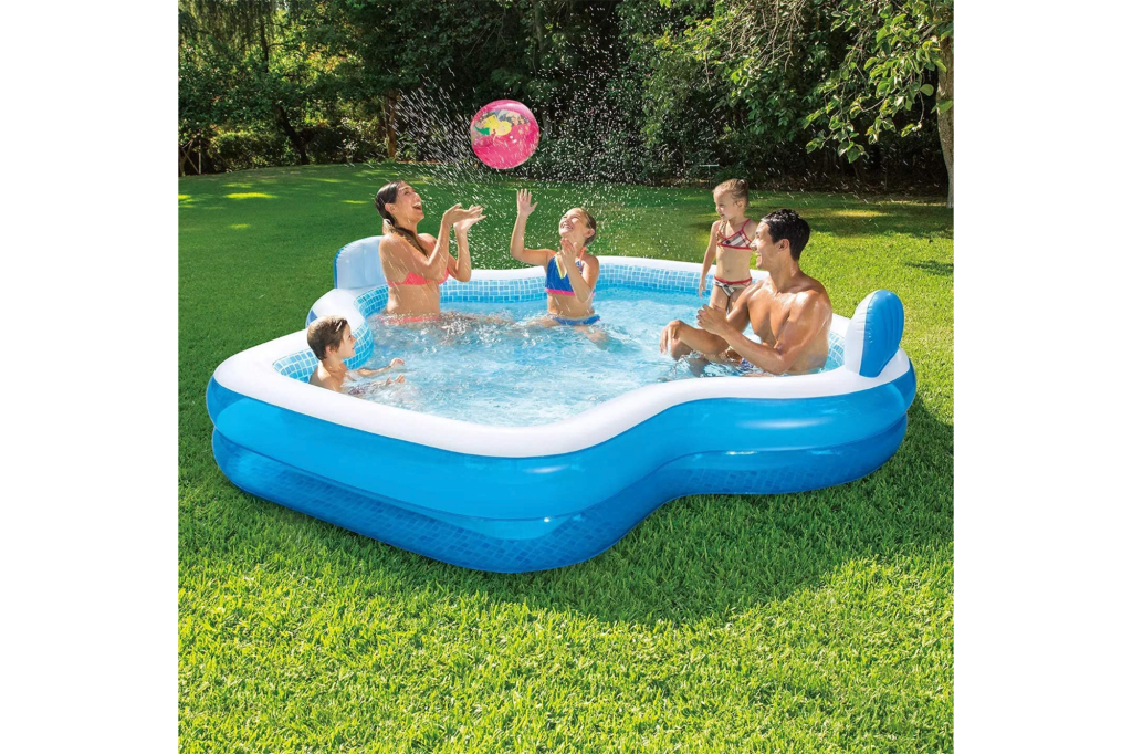 Family swimming in pool outside