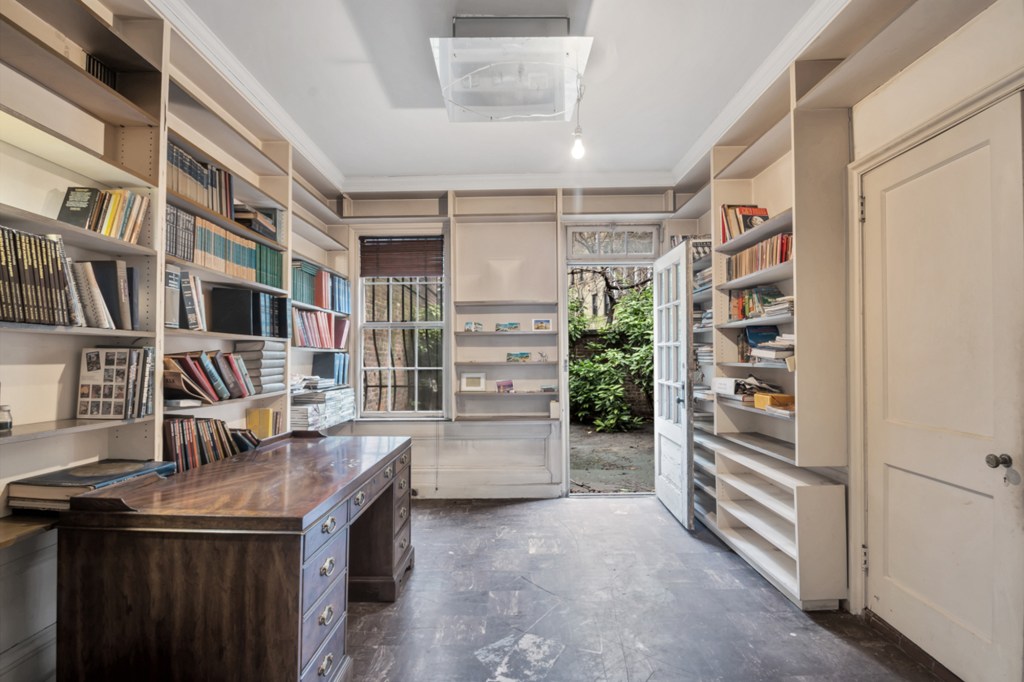 An office with built-in bookshelves.