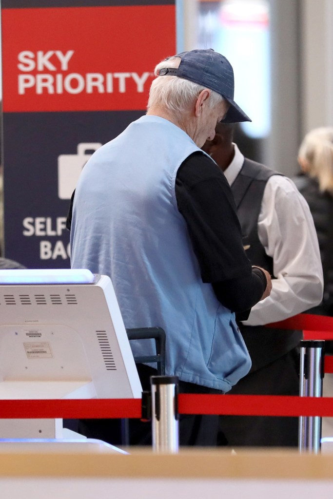 Bill Murray is seen talking to an airlines employee.