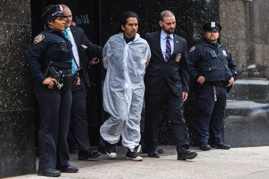 David Bonola is walked from the 112th precinct on April 21.