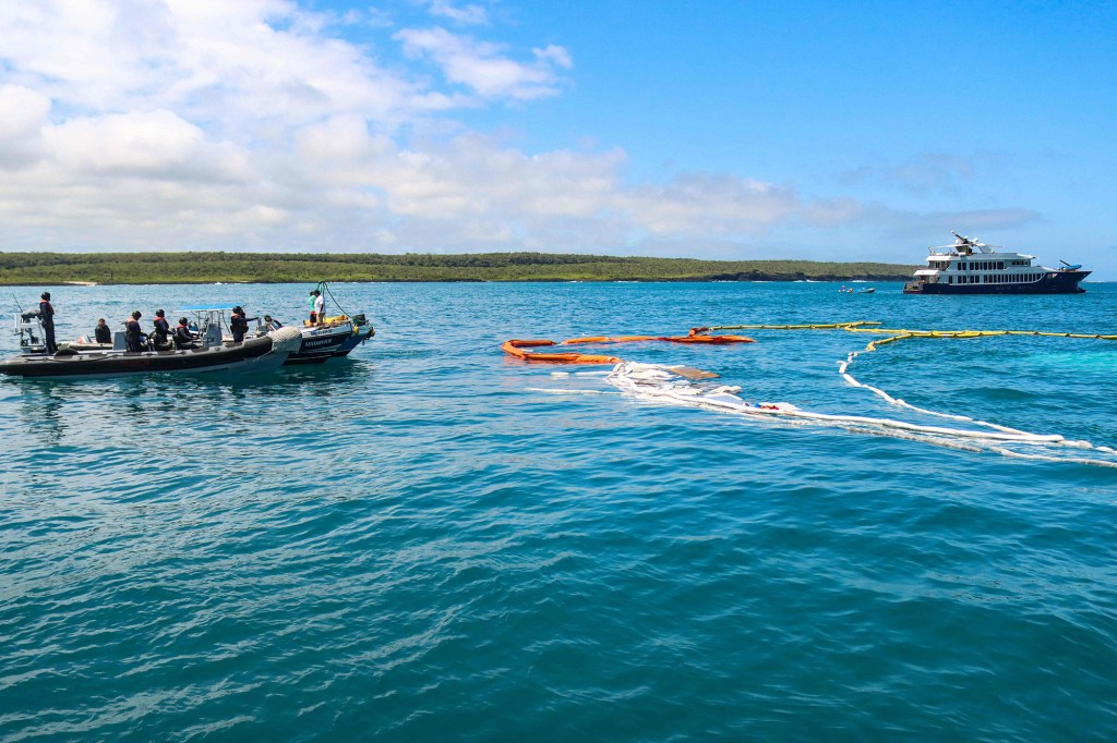 Coastguards check the site where a boat sank on April 23, 2022 near Puerto Ayora in Santa Cruz Island, in the Galapagos Islands.