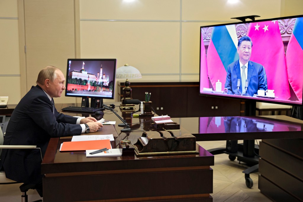 Russian President Vladimir Putin talks with Chinese President Xi Jinping via videoconference at the Novo-Ogaryovo residence outside Moscow, Russia, Dec. 15, 2021