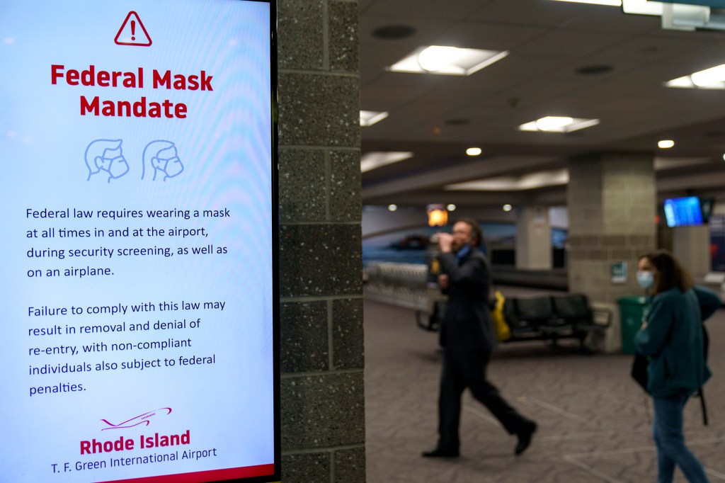 Instructions on a federal mask mandate is still displayed on a screen as Rhode Island T.F. Green International Airport worked on updating their signage Tuesday, April 19