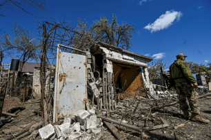 A Ukrainian service member stands at the site of residential houses damaged by a missile attack in Zaporizhzhia, Ukraine on April 28, 2022.