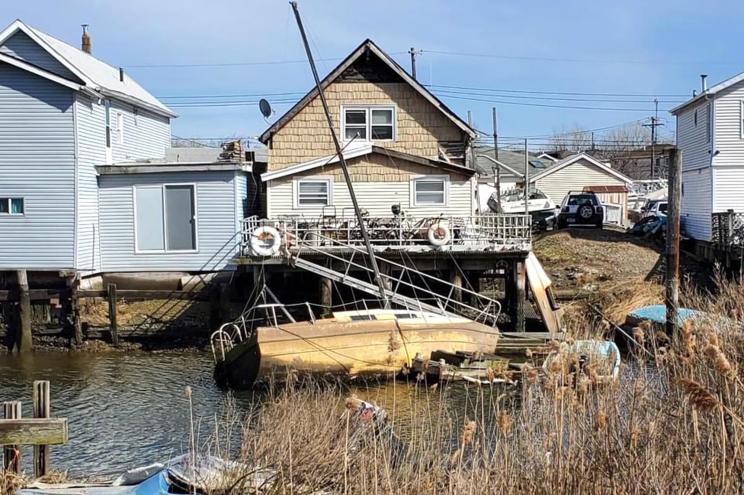 Abandoned boats float in Jamaica Bay.