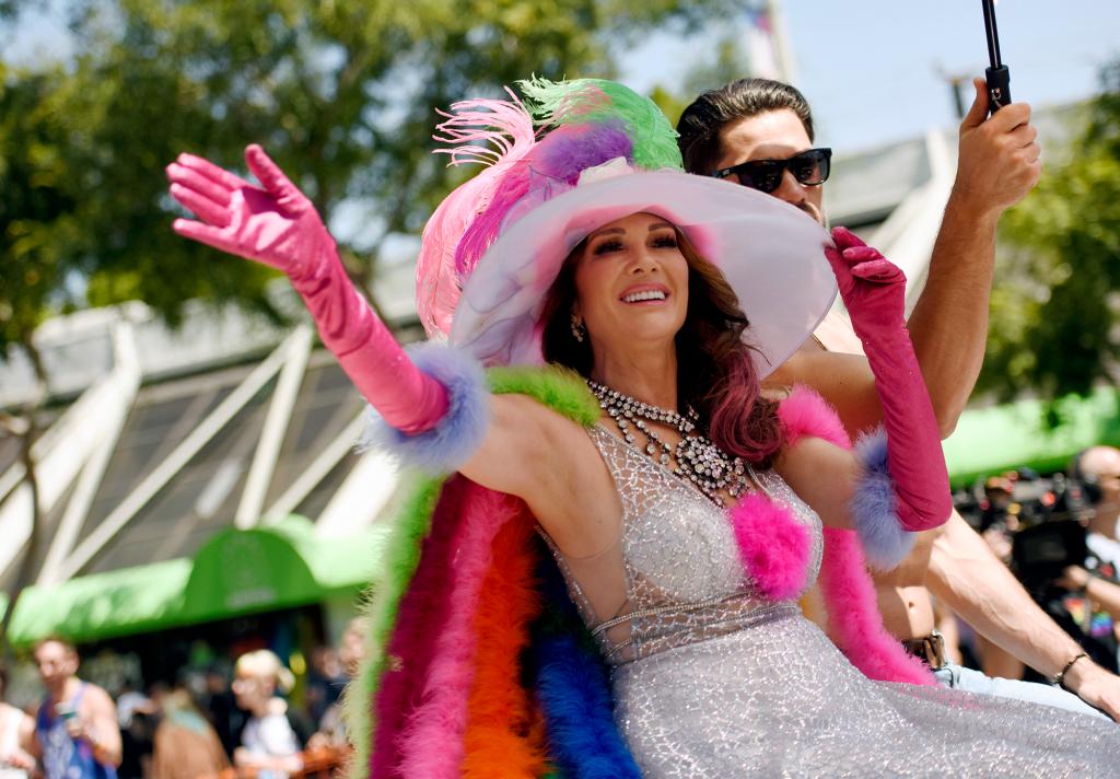 Lisa Vanderpump in a wide brimmed hat and pink gloves.