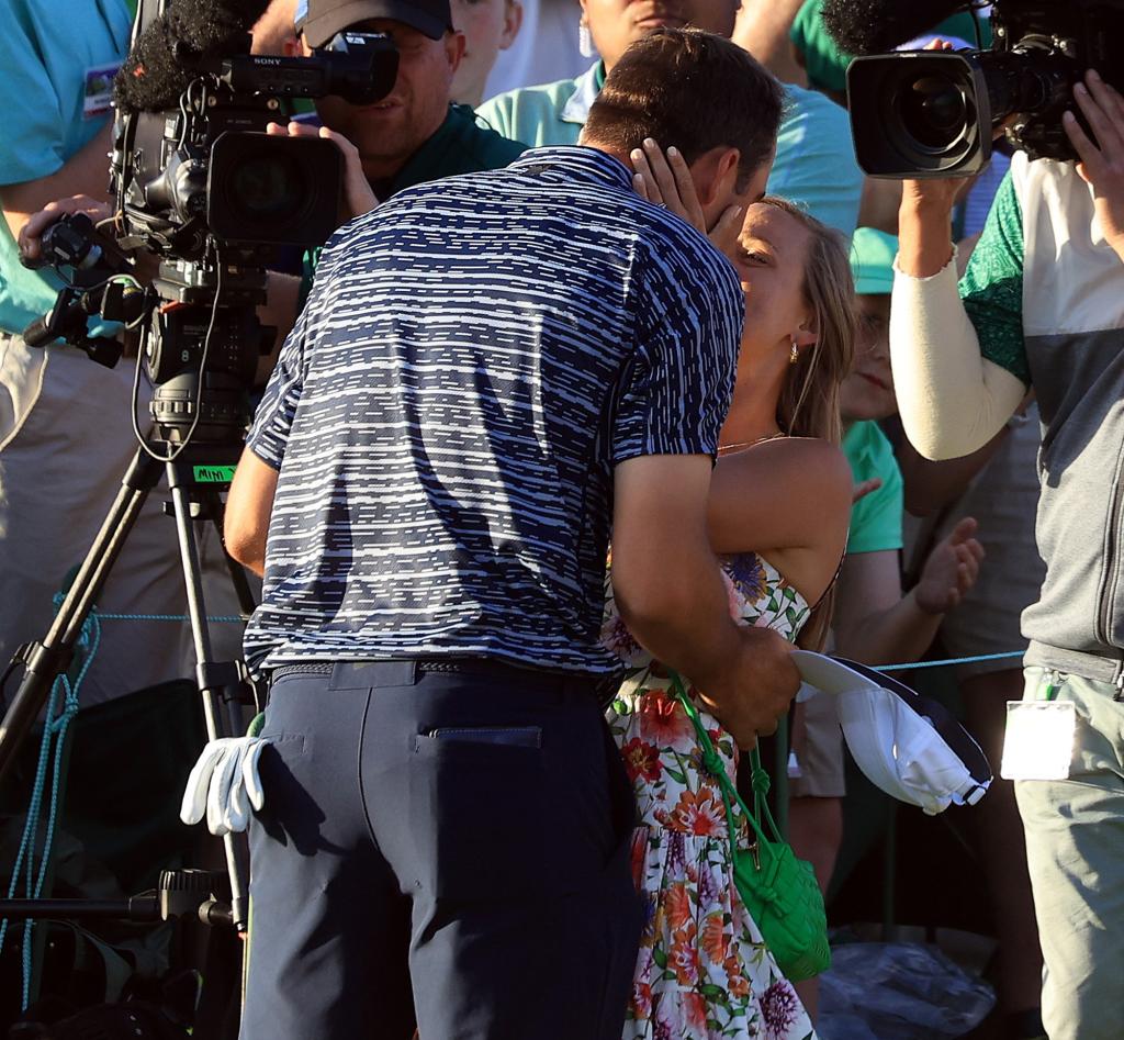 The couple embraces one another on the course at Augusta National on April 10, 2022