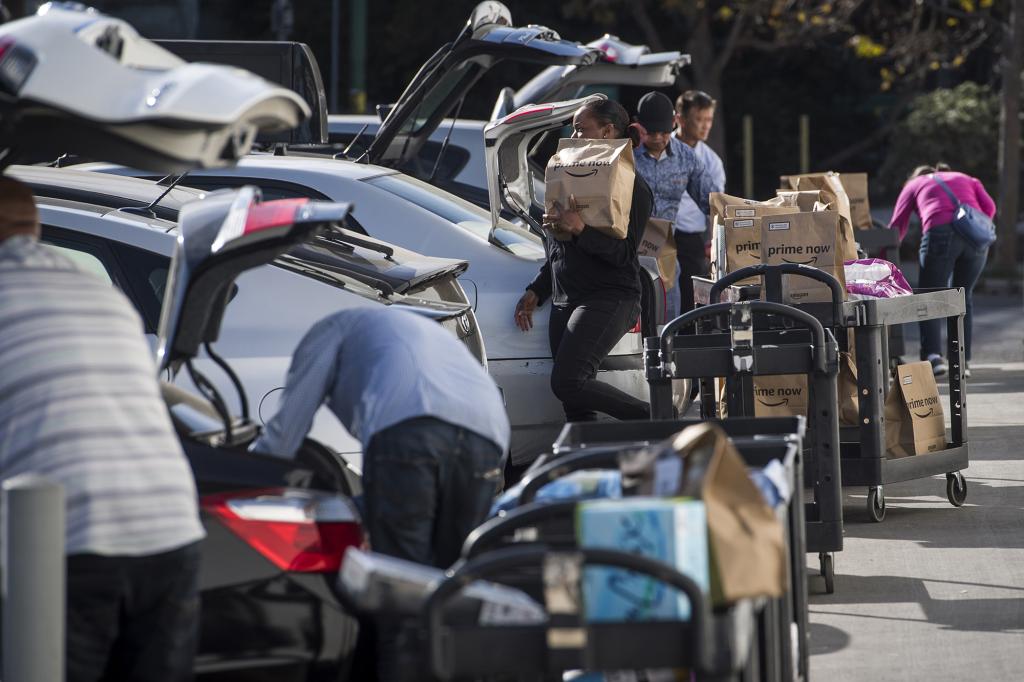 Amazon Flex drivers loading up their cars with packages.