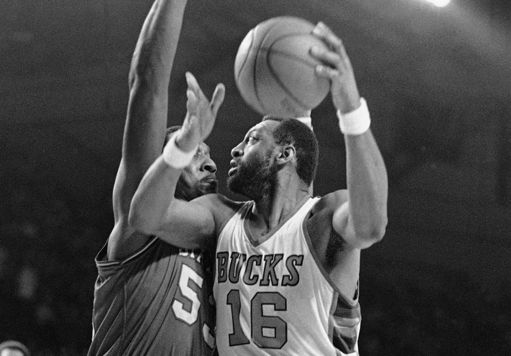 The Bucks' Bob Lanier looks to shoot over 76ers big man Darryl Dawkins during a 1981 NBA playoff game.