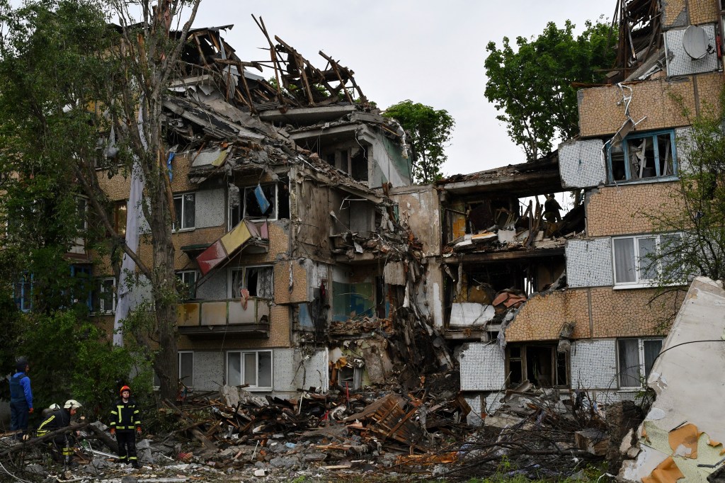 Rescuers work at a site of an apartment building destroyed by Russian shelling in Bakhmut, Ukraine, on May 18, 2022. 