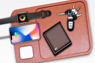 A leather brown tray with phones a wallet and more