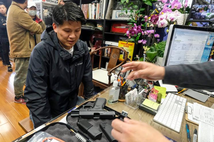 Brian Xia, 44, picks up his gun at a gun store in Arcadia, California.