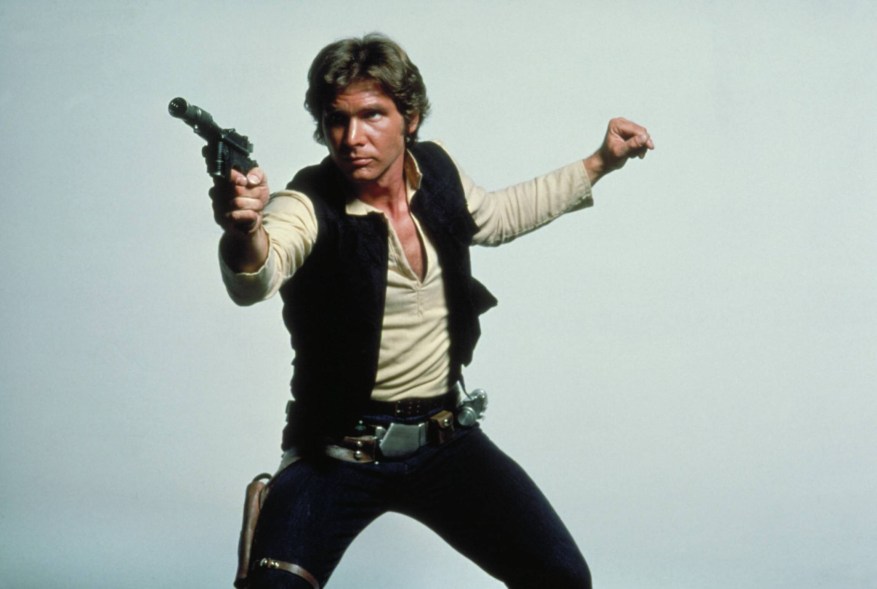 Han Solo holds up a gun.