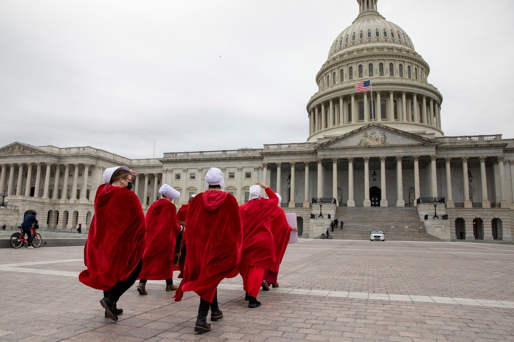 Abortion-rights protesters dressed in costumes from the "Handmaid's Tale," walk to the U.S. Capitol building