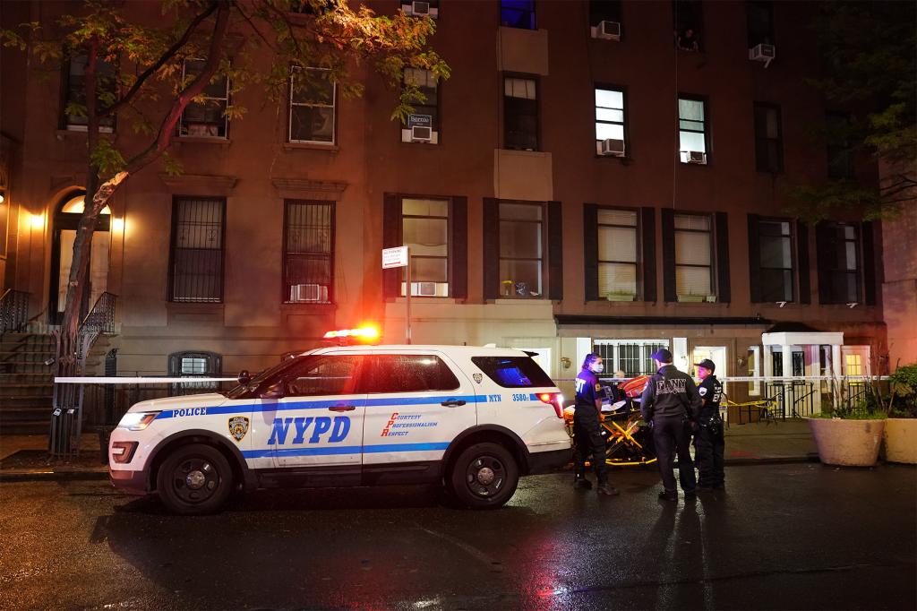 NYPD officers outside the building where a 47-year-old man was injured in a self-inflicted shooting in Hell's Kitchen on May 28, 2022.