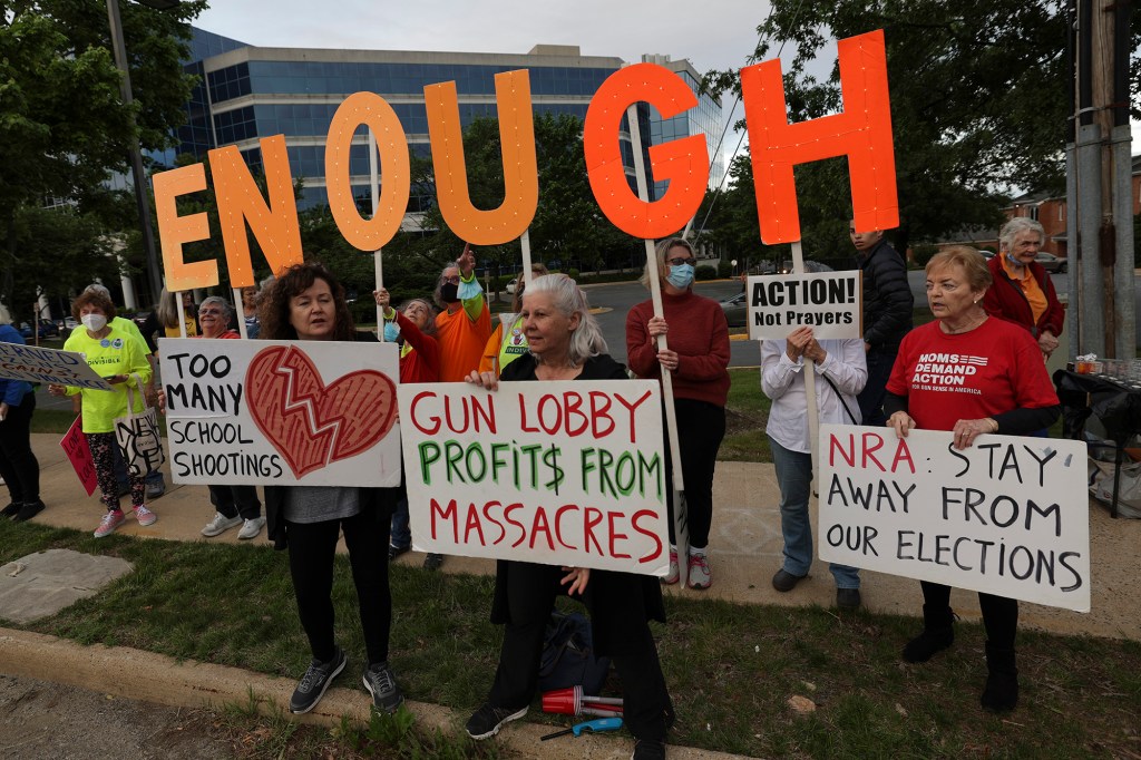 Gun-control advocates hold a vigil outside of the National Rifle Association (NRA) headquarters following the recent mass shooting at Robb Elementary School on May 25, 2022. NRA hosted its convention in Houston this weekend.