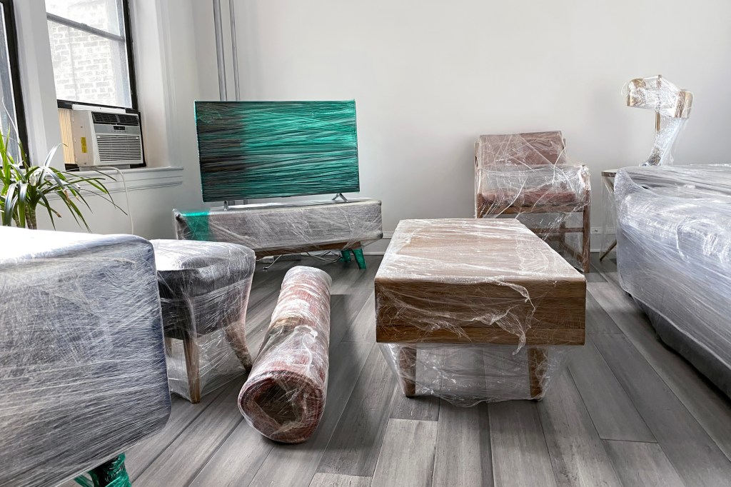 Furniture wrapped in plastic and ready to be moved.