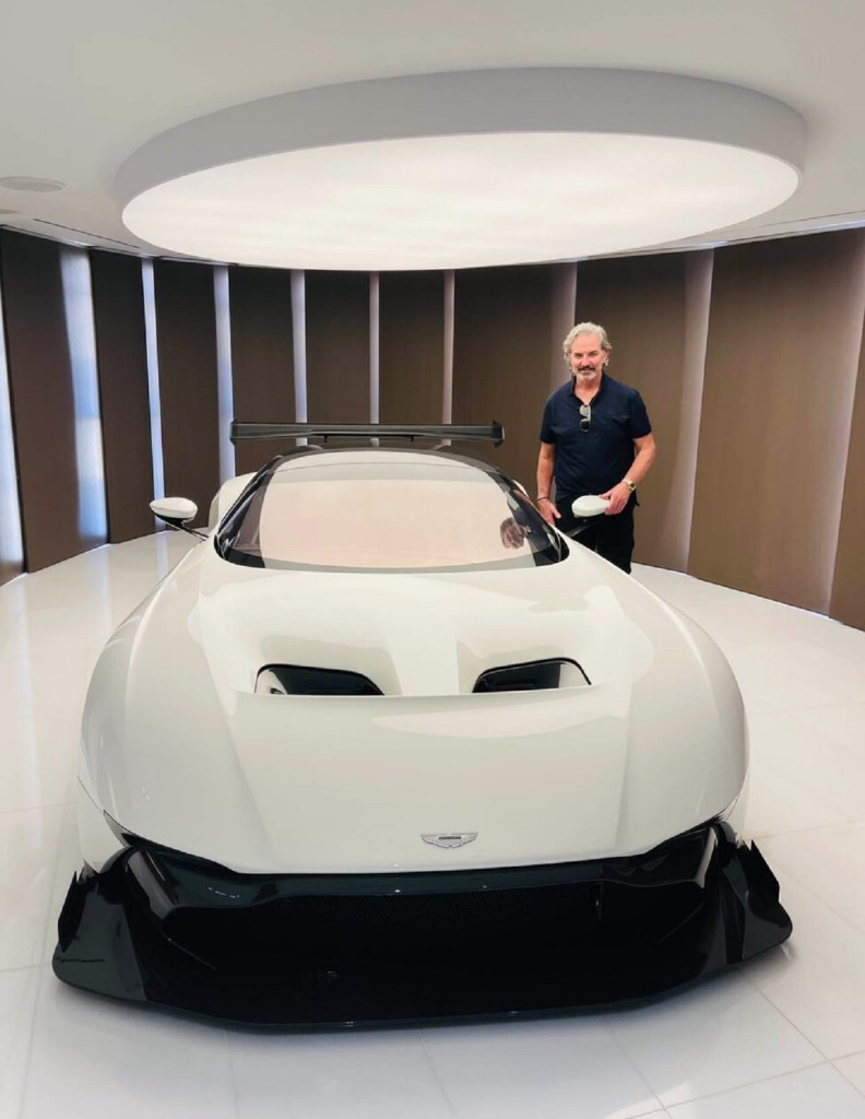 Interior of Les Woods next to an Aston Martin 