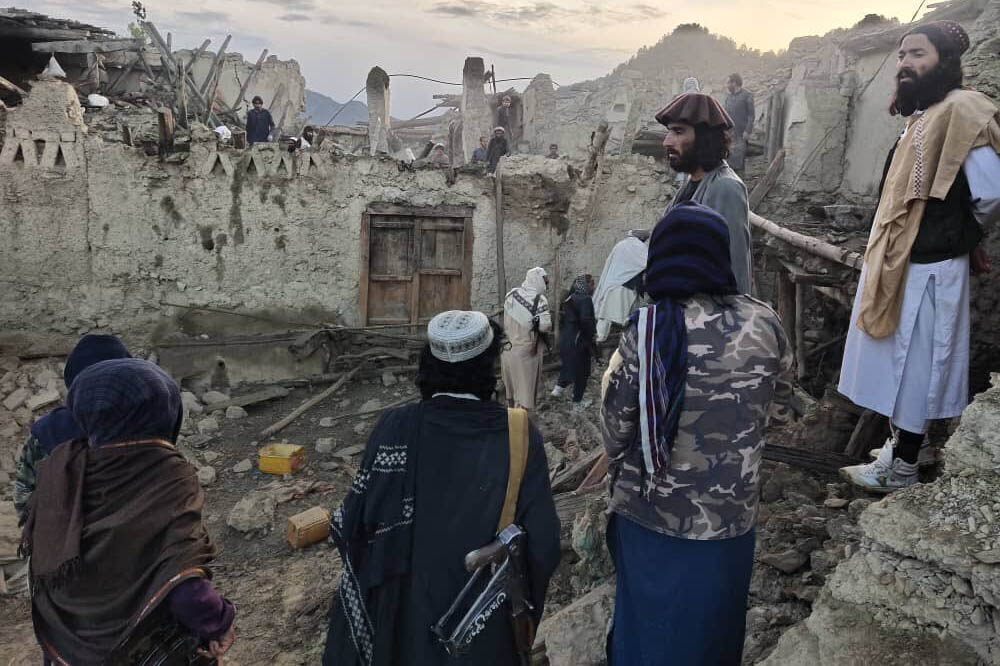 Afghans look at destruction caused by an earthquake in the province of Paktika, eastern Afghanistan.