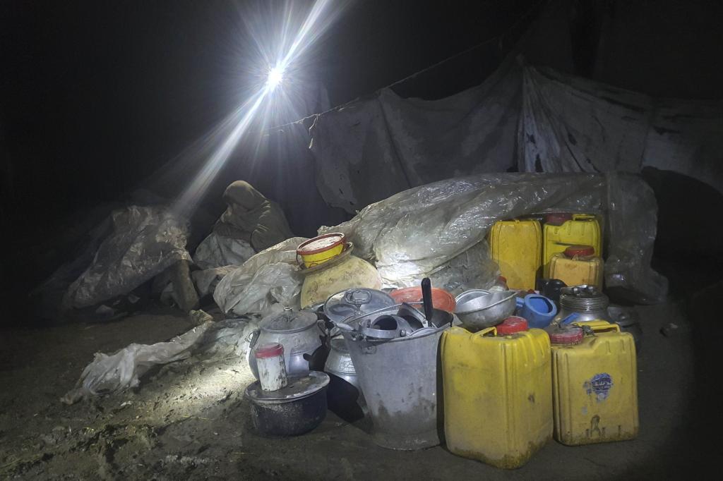 A woman sits inky a makeshift shelter in the village of Gyan, in Paktika province, Afghanistan.