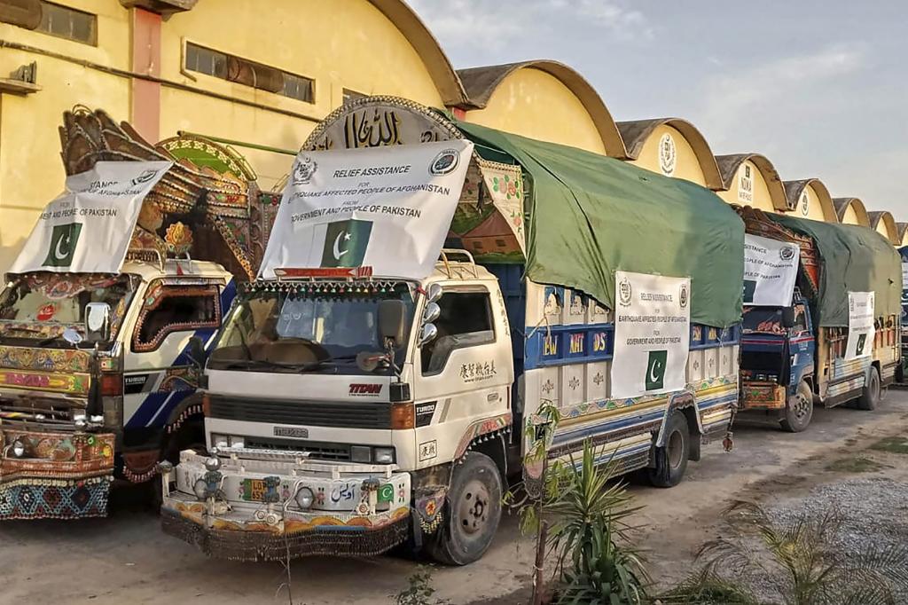 A convoy of trucks carrying relief good including tents, blankets and emergency medicines for Afghanistan's earthquake hit areas, prepare to leave for Afghanistan at a warehouse in Islamabad, Pakistan.