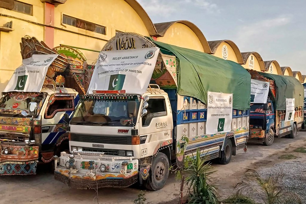 A convoy of trucks carrying relief good including tents, blankets and emergency medicines for Afghanistan's earthquake hit areas, prepare to leave for Afghanistan at a warehouse in Islamabad, Pakistan.