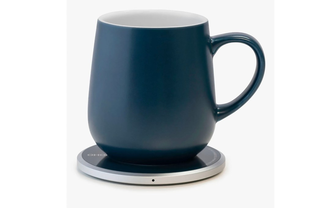 A blue mug on a warmer pad 