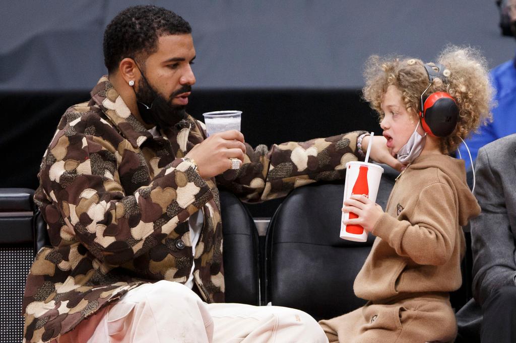 Toronto rapper Drake and his son Adonis cheers cups.