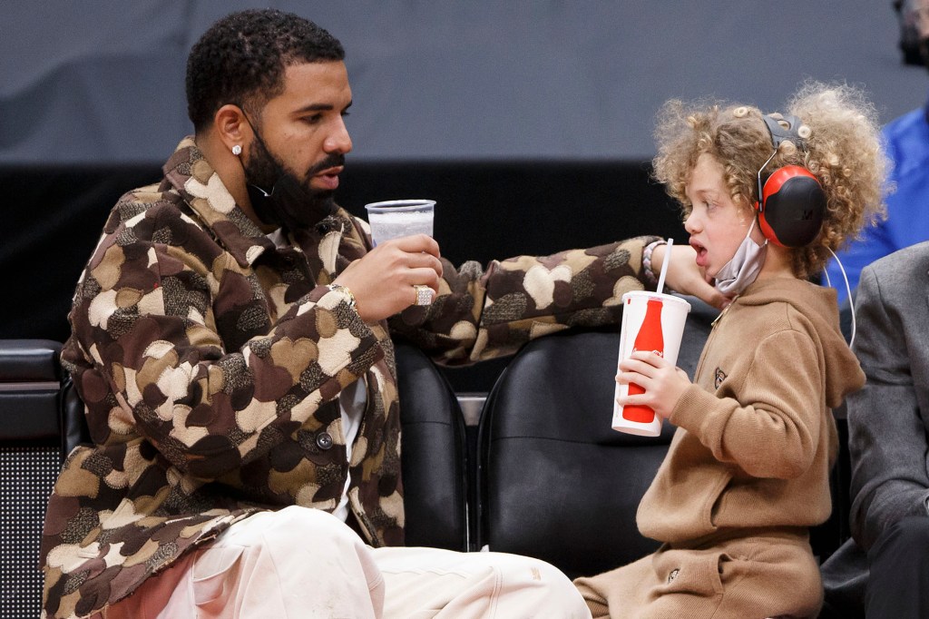 Toronto rapper Drake and his son Adonis cheers cups. 