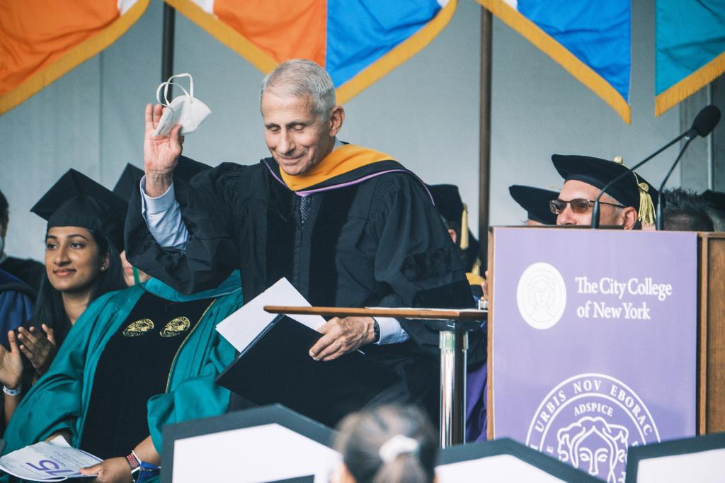 Dr. Anthony Fauci removes his mask before delivering his commencement speech at the City College of New York.